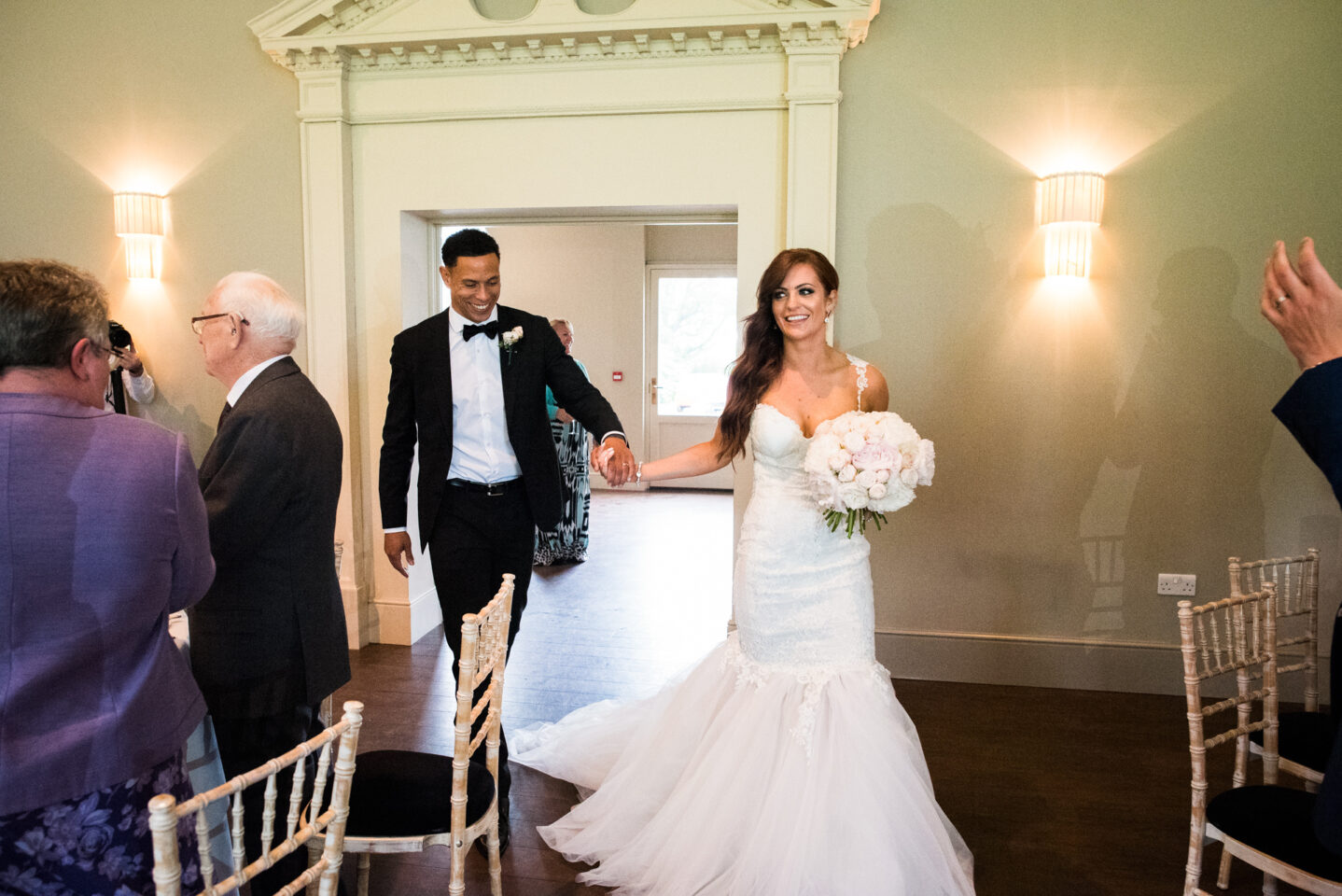 bride and groom enter the wedding breakfast
